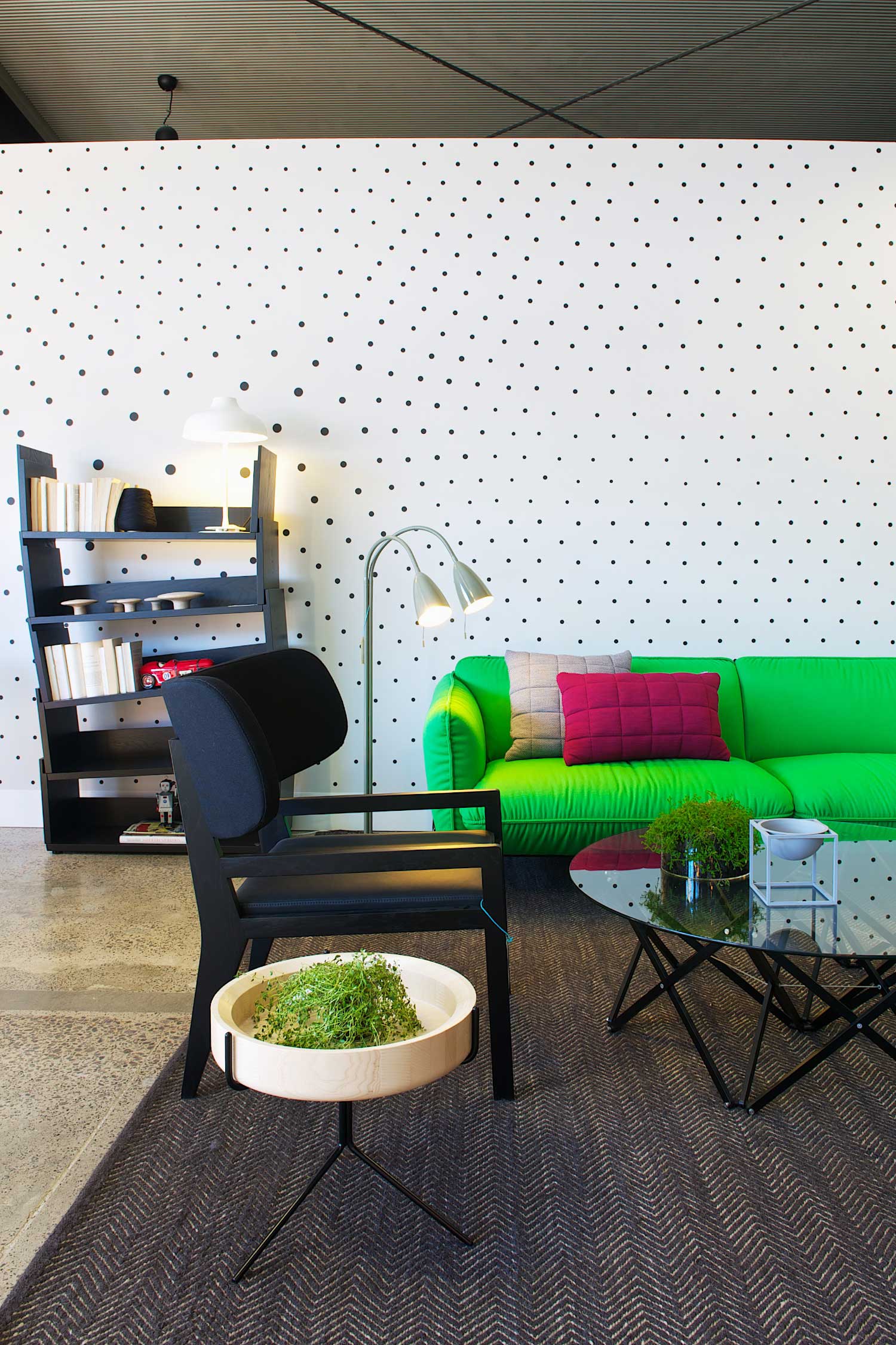 Fred International Sydney Showroom by Yellowtrace | Photo © Nick Hughes. Fred International Sydney Showroom by Yellowtrace. Swedese Black Ivy bookshelf, white Bolero light by Ruben Lighting, Swedese green Continental Sofa, Muuto Cushions, Swedese Cartoon Chair, Karl Anderson & Söner Itomaki coffee table, grey Bowl By Lassen. Swedese Drum side table, Ruben Arkipelag twin floor lamp. Armadillo & Co Herringbone Weave rug, Custom black dot wall decal by War Design.