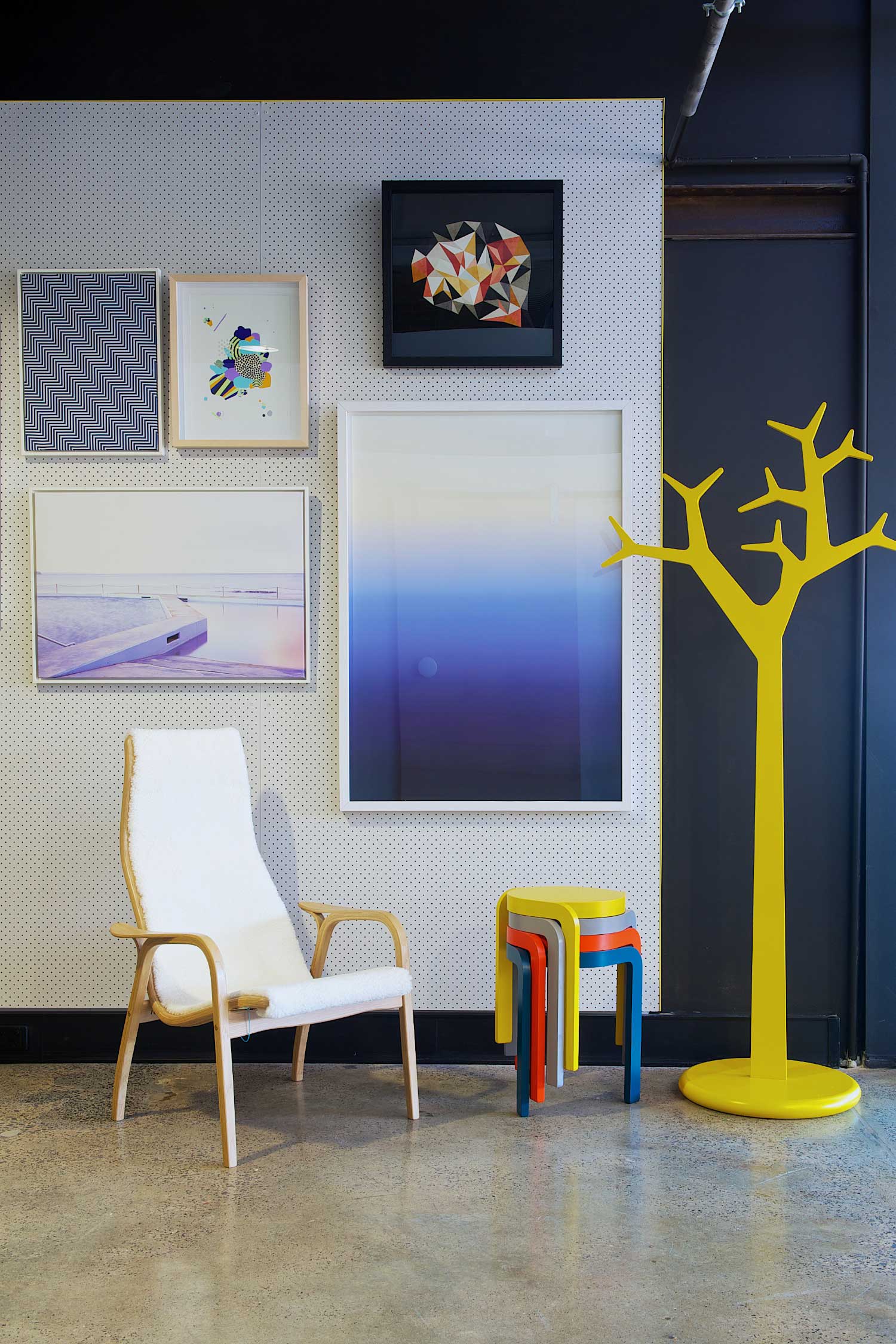 Fred International Sydney Showroom by Yellowtrace | Photo © Nick Hughes. Fred International Sydney Showroom by Yellowtrace, Swedese Lamino Chair in oak frame and white sheepskin, Swedese Spin stools, Swedese Tree in yellow, artwork by I Need Nice Things.